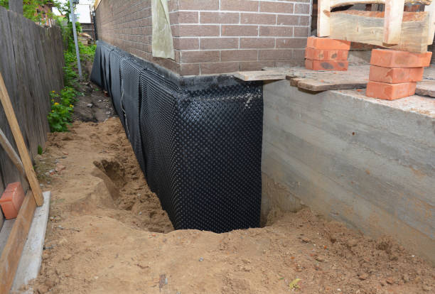 Happy homeowners after waterproofing job in Olcott